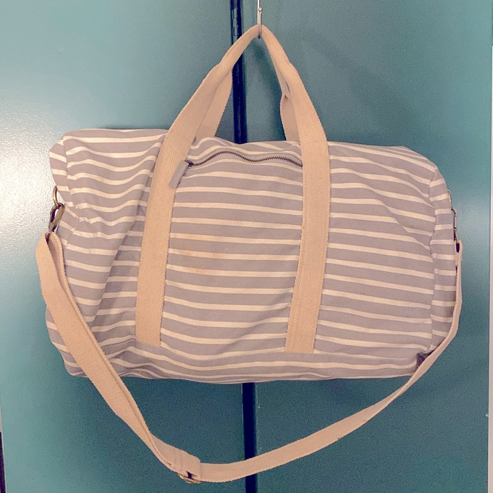Striped gray and white weekender duffle bag.